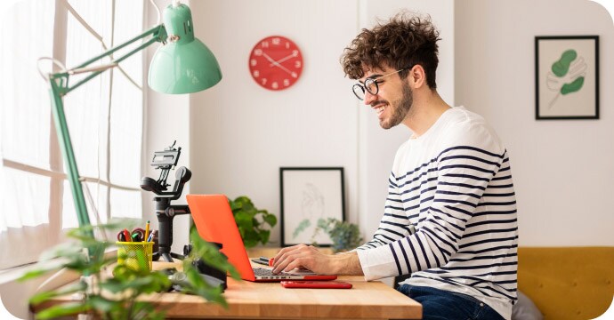 Man sitting on his laptop smiling