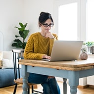 A woman uses caution while inputting her address online.