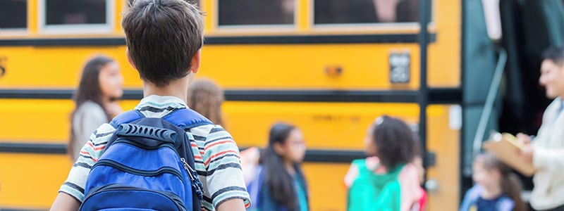 Students get ready to board a school bus