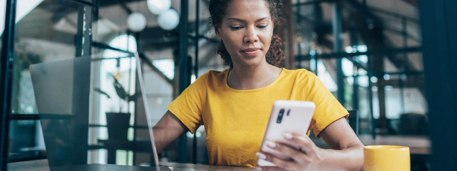 A woman reads about employment identity theft on her smartphone.