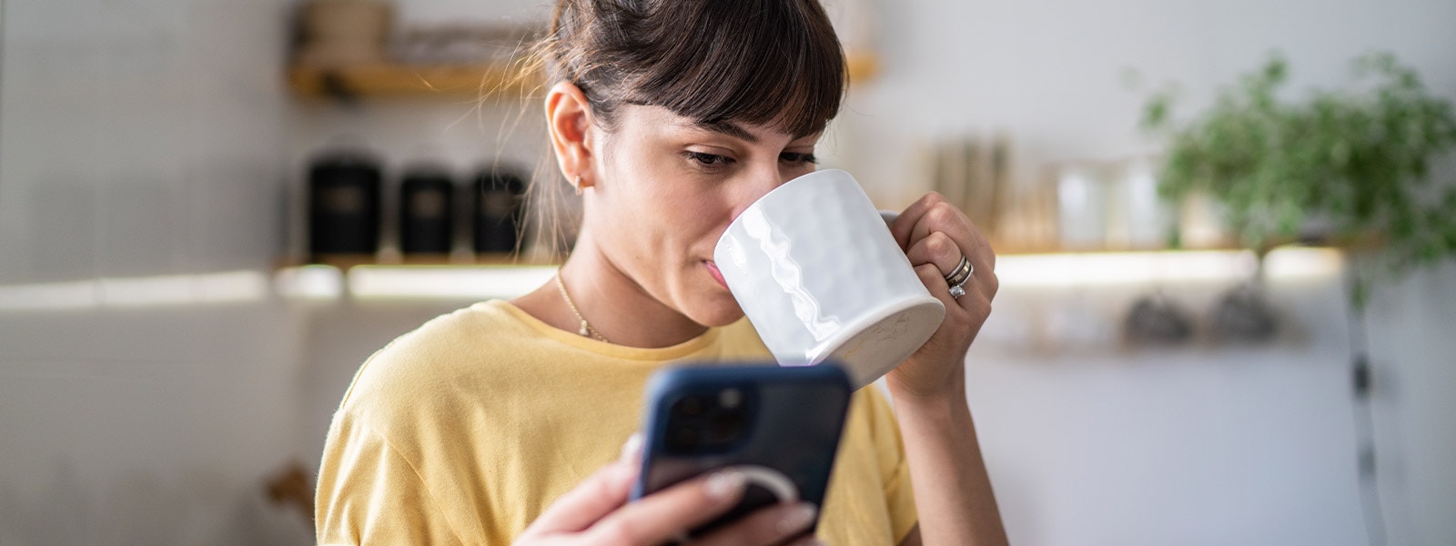 A woman uses her phone to learn about the potential risks and what happens if you lose your Social Security card.