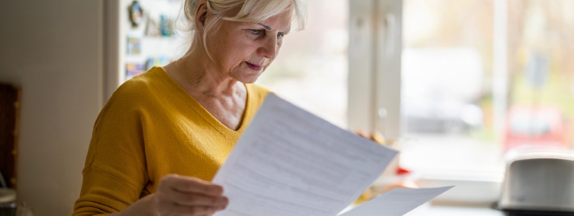 Woman looking at papers learning about how common identity theft is.