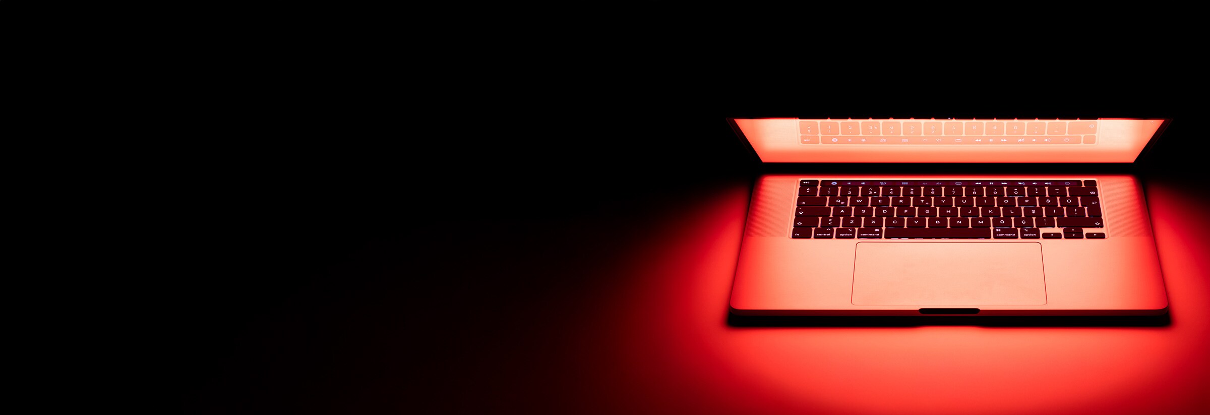 A hacked computer emitting red light.