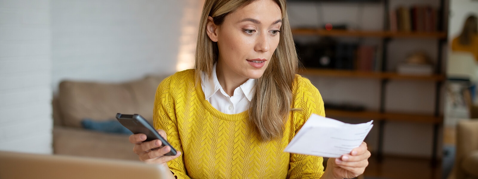 A person learning how to recover from identity theft on their phone.