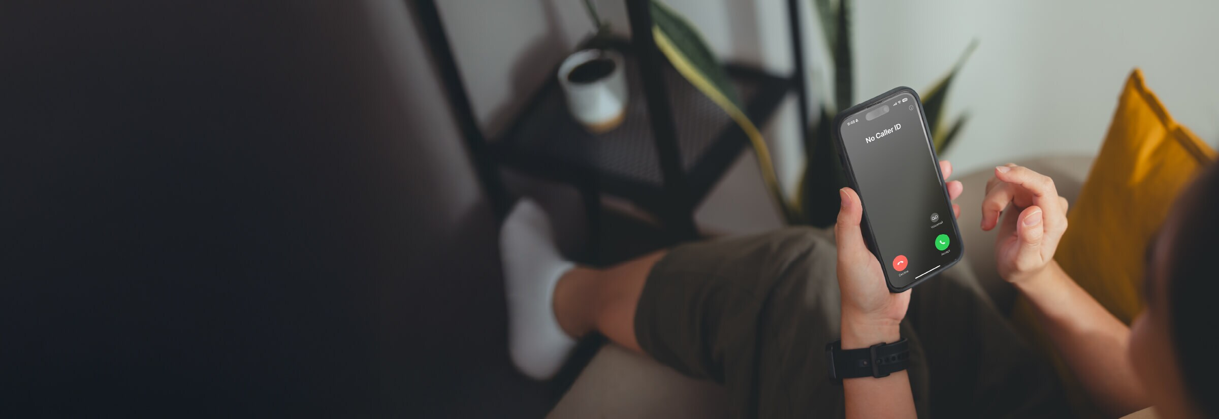 An image of a person looking at a call spoofing their own number.