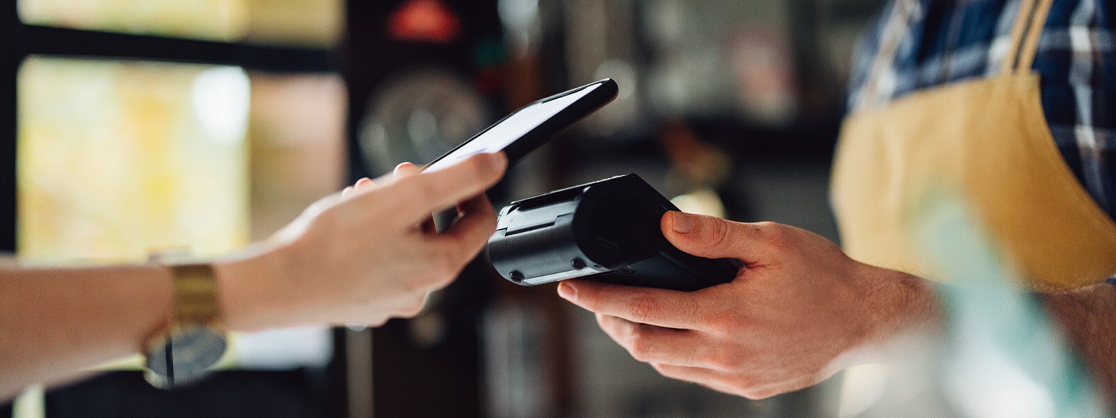 A customer uses Apple Pay at a local coffee shop.