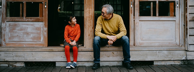 Young girl sits with her grandfather and discusses identity theft.