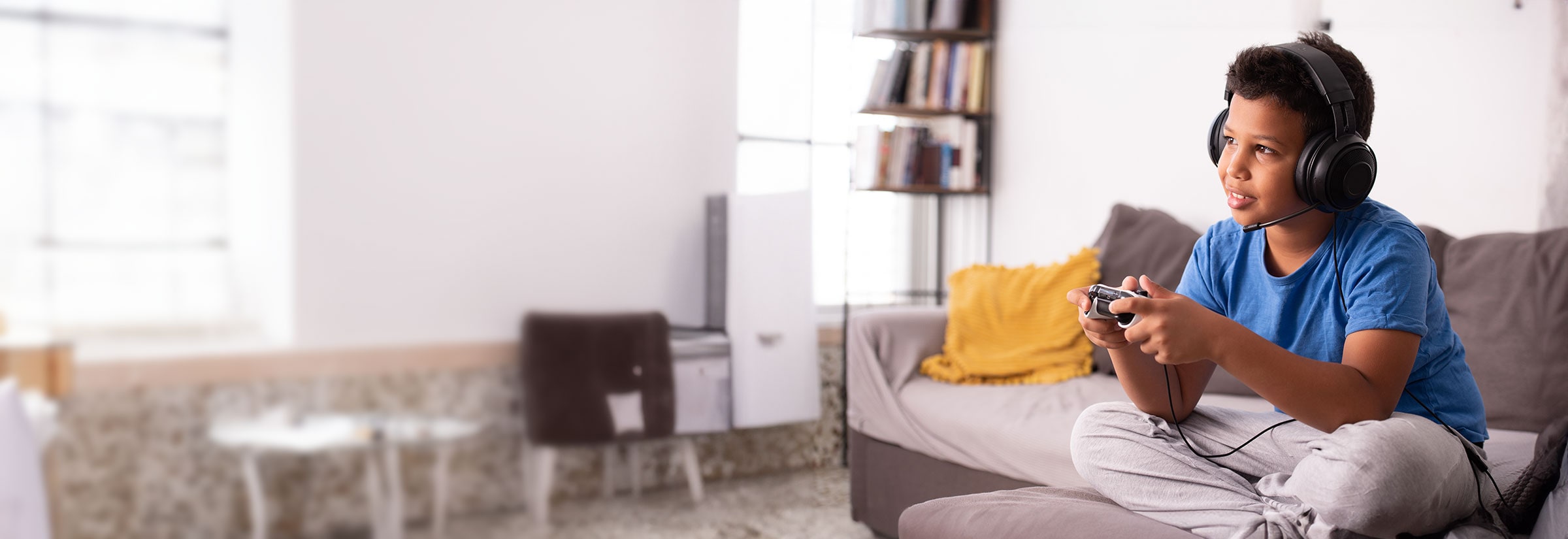 A child playing a video game on a couch