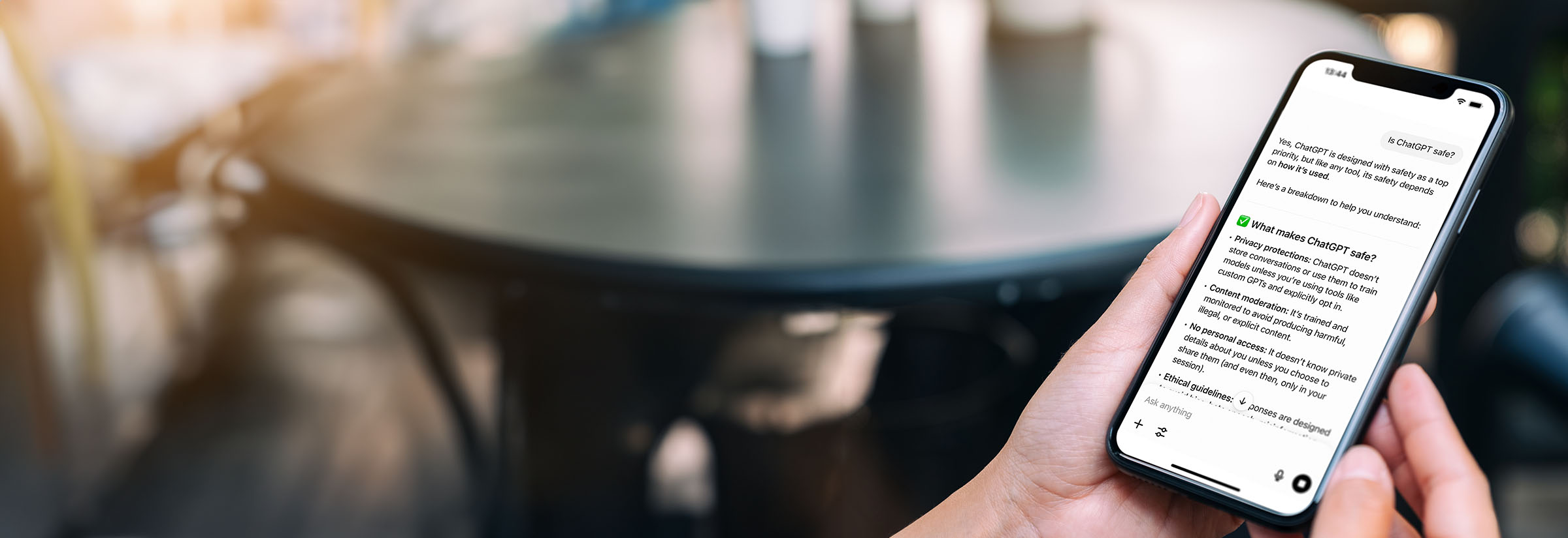 A mobile phone with text on the screen answering whether ChatGPT is safe and why.