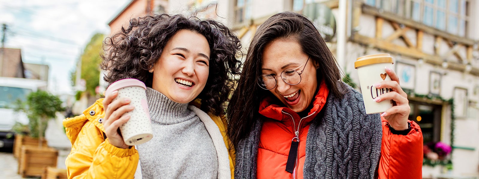 Two friends grab coffee after learning the answer to the question, "Is identity theft protection worth it?"