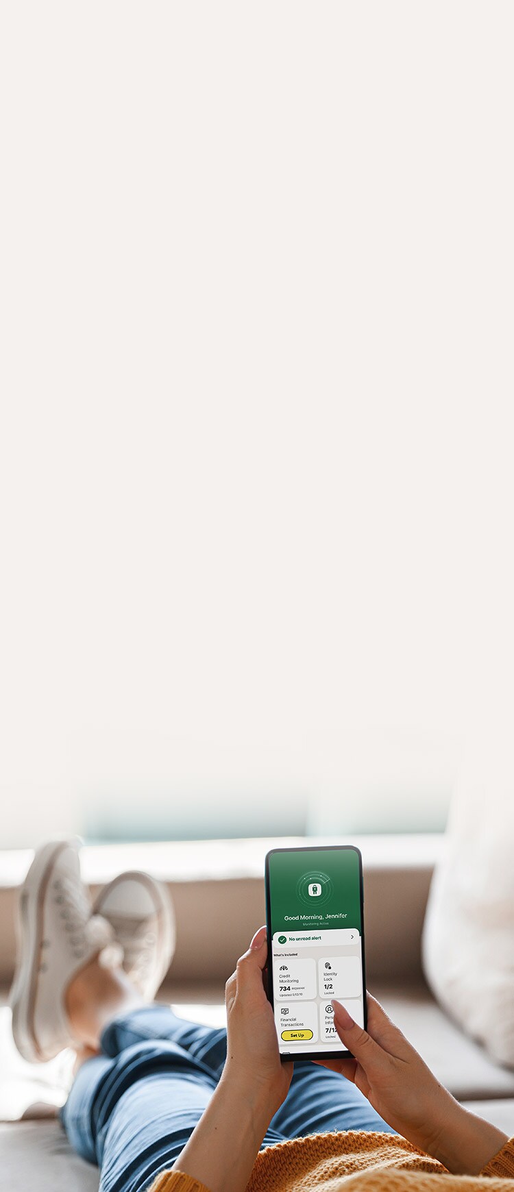 A woman checks an identity theft alert in the LifeLock app. 