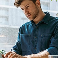 A man researches on his laptop how to replace a lost Social Security card.