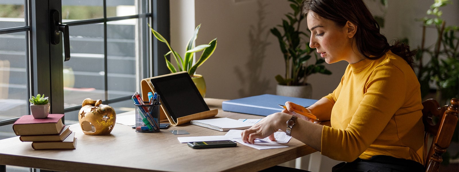 A person examining paperwork to look for potential signs of medical identity theft.