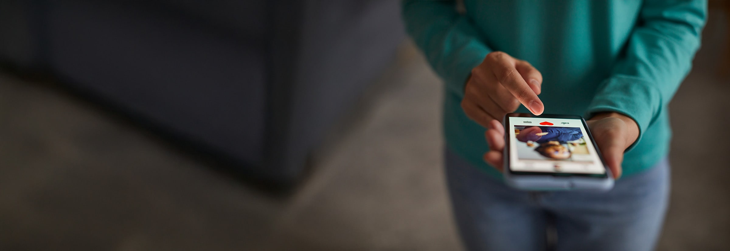 A person liking a profile on a dating app on their phone.