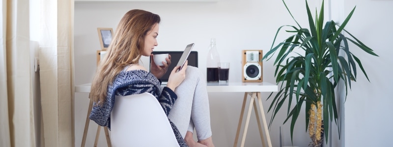 Woman on tablet looking at her social accounts.