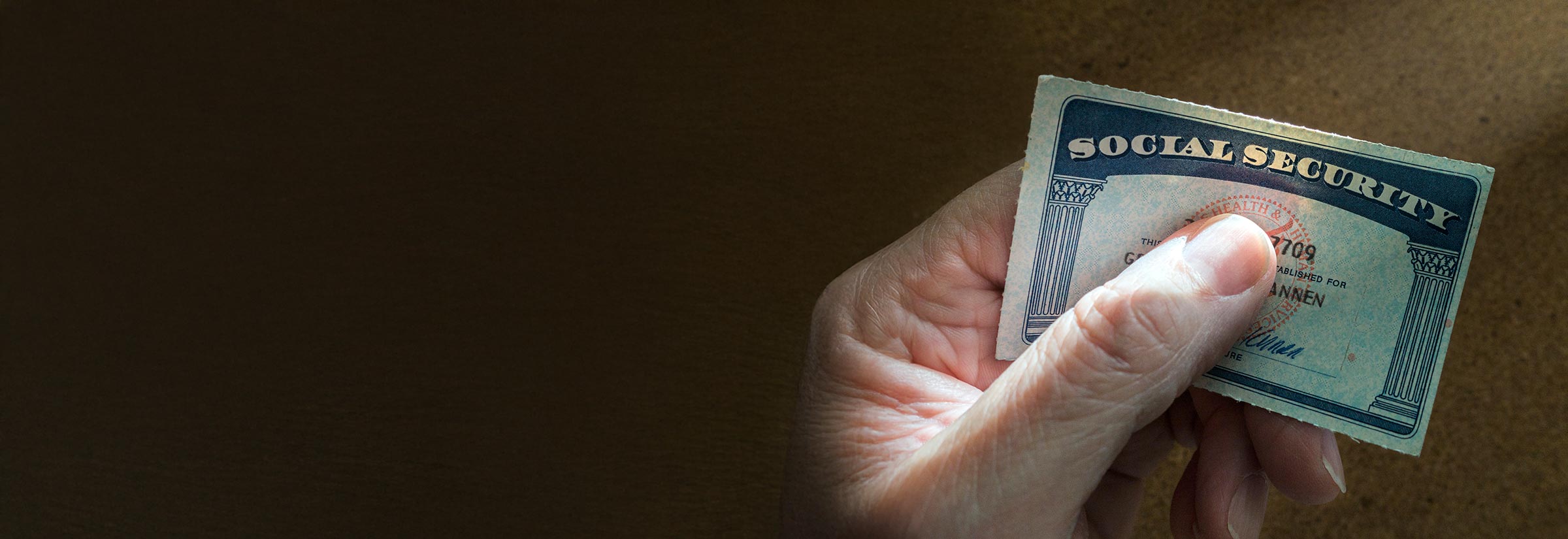 A person holds their Social Security card.