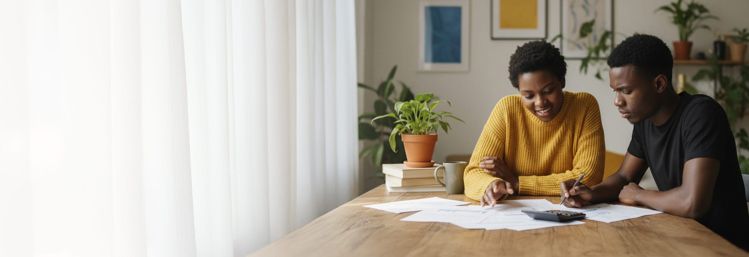 Two people reviewing tax documents while submitting their tax return.