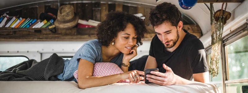 A couple using a phone to research their name on Google, exploring what a Google search reveals about them.