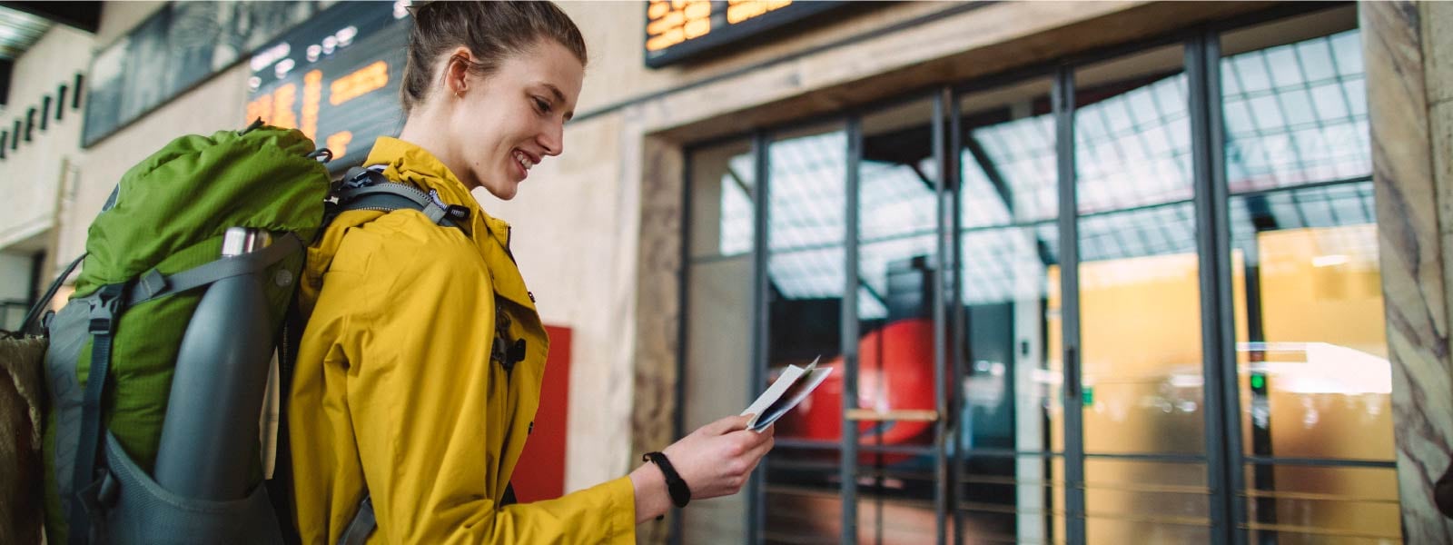 A woman enters the airport after reading about what to do if you lose your passport.