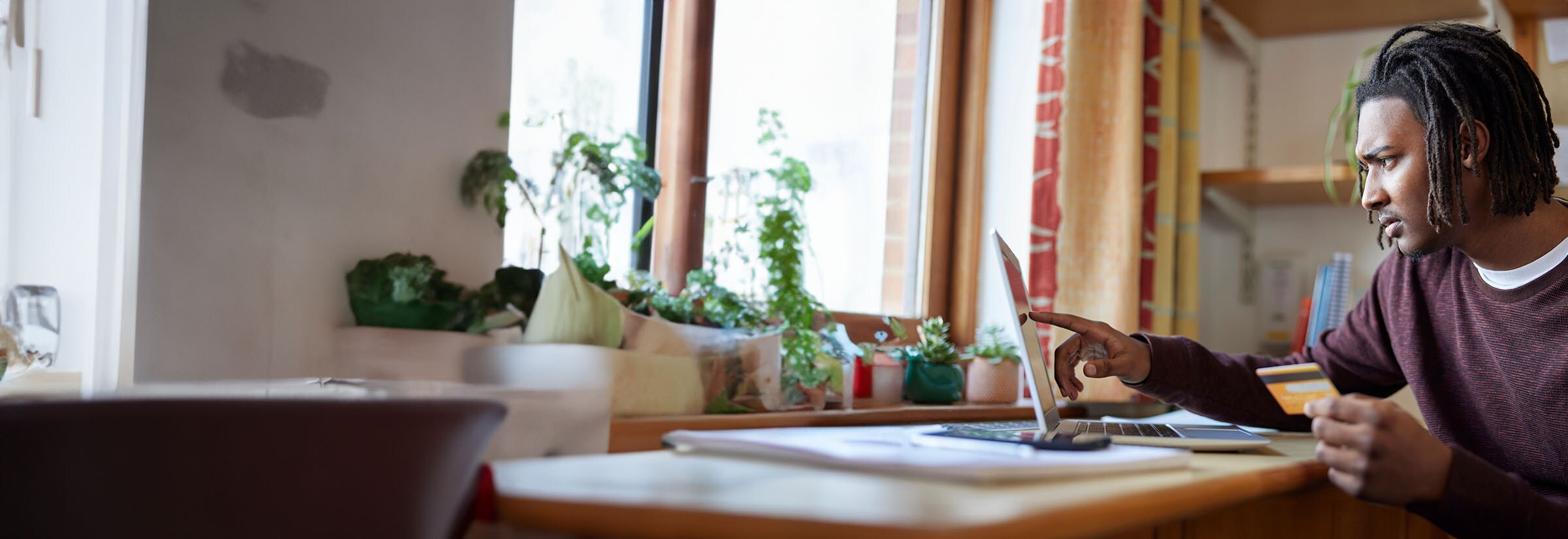 A man on his laptop trying to find out who charged his credit card.