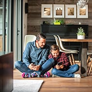 Dad and his son check their fantasy football scores after taking steps to protect their personal information.