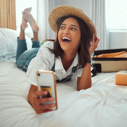 A lady in an Airbnb apartment using her mobile.