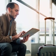 Man working on his laptop while at the airport.