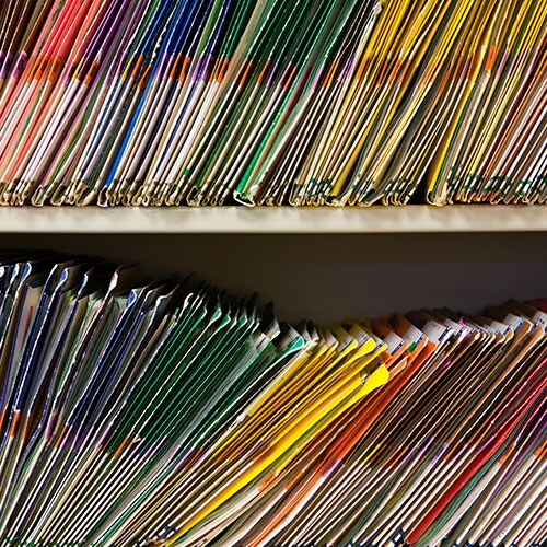 Two young people look at their tax records on a laptop.