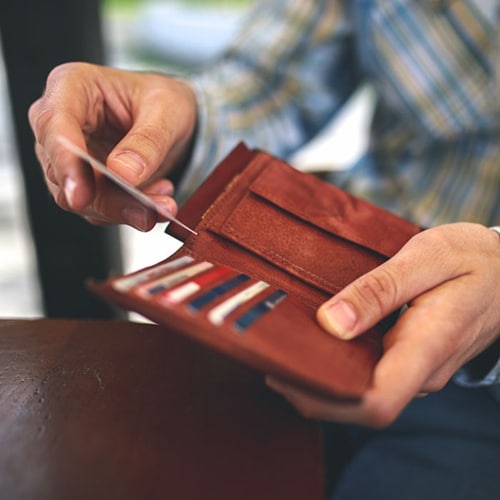 A person looking at how many credit cards they have in their wallet.