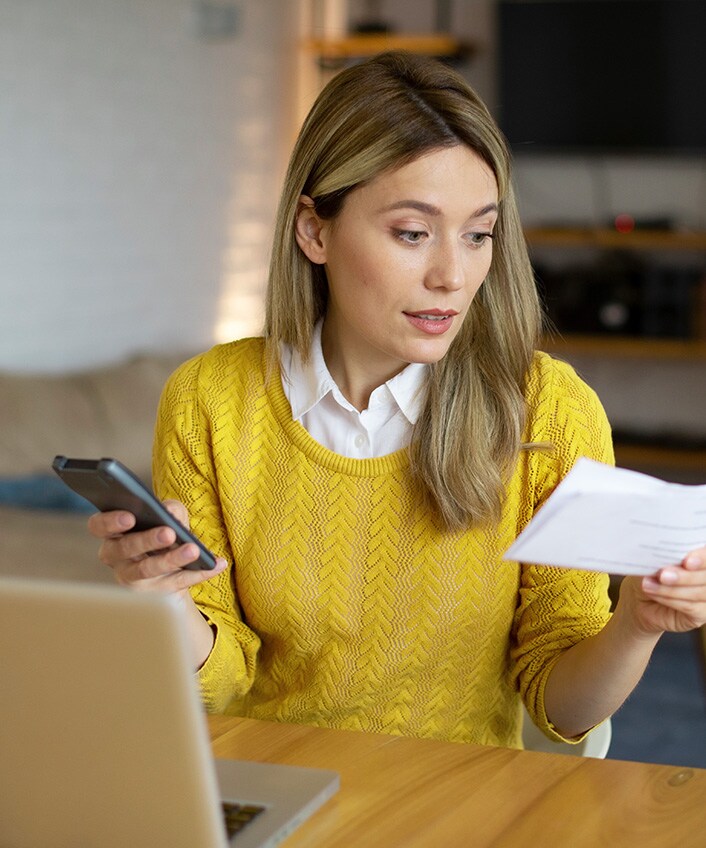 A person learning how to recover from identity theft on their phone.