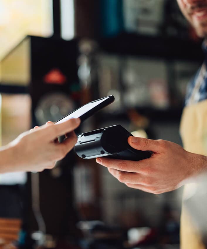 A customer uses Apple Pay at a local coffee shop.