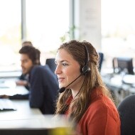 LifeLock Identity Restoration Specialists seen answering a call from a customer.