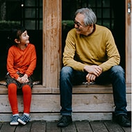 Young girl sits with her grandfather and discusses identity theft.