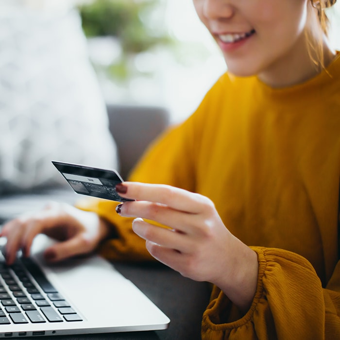 Woman purchasing something online with a credit card