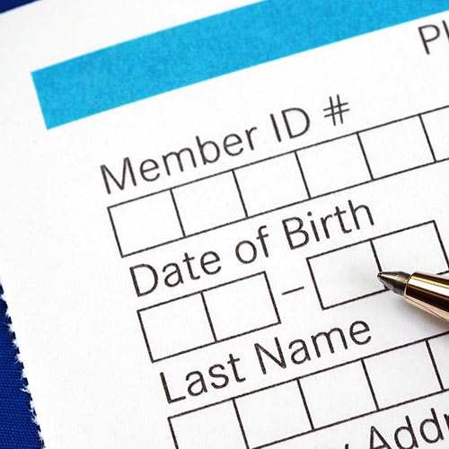 A woman holds her passport book which contains personally identifiable information (PII).