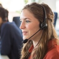 Technical support person shown answering a customer call.