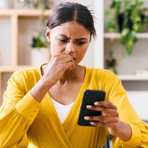 A woman reads a message notifying her of a data leak.