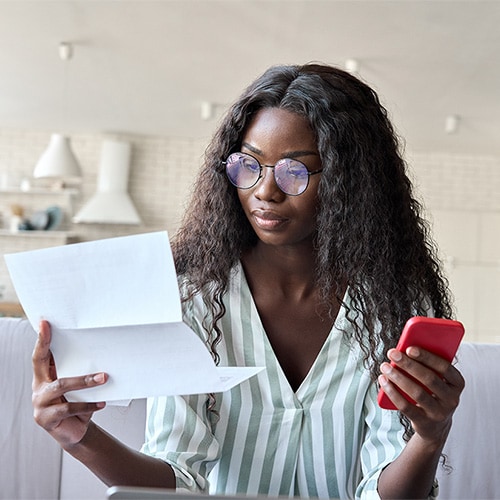 A woman gets a notification on her phone about his social security number being exposed.